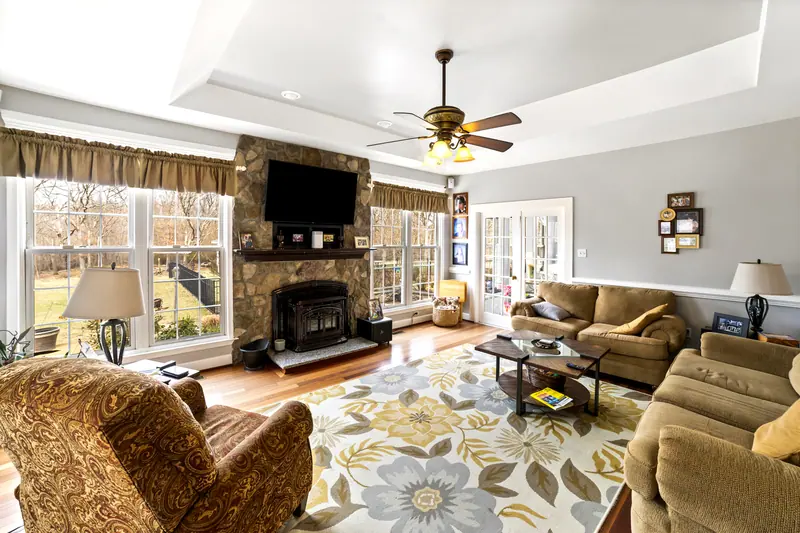 Family room with stone fireplace in Catonsville, MD