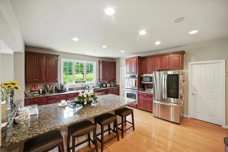 Kitchen with granite island and cherry cabinets in Leesburg, VA