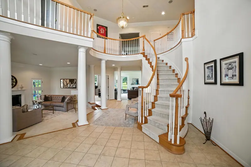 Two-story foyer with a curved staircase in a Leesburg, VA home
